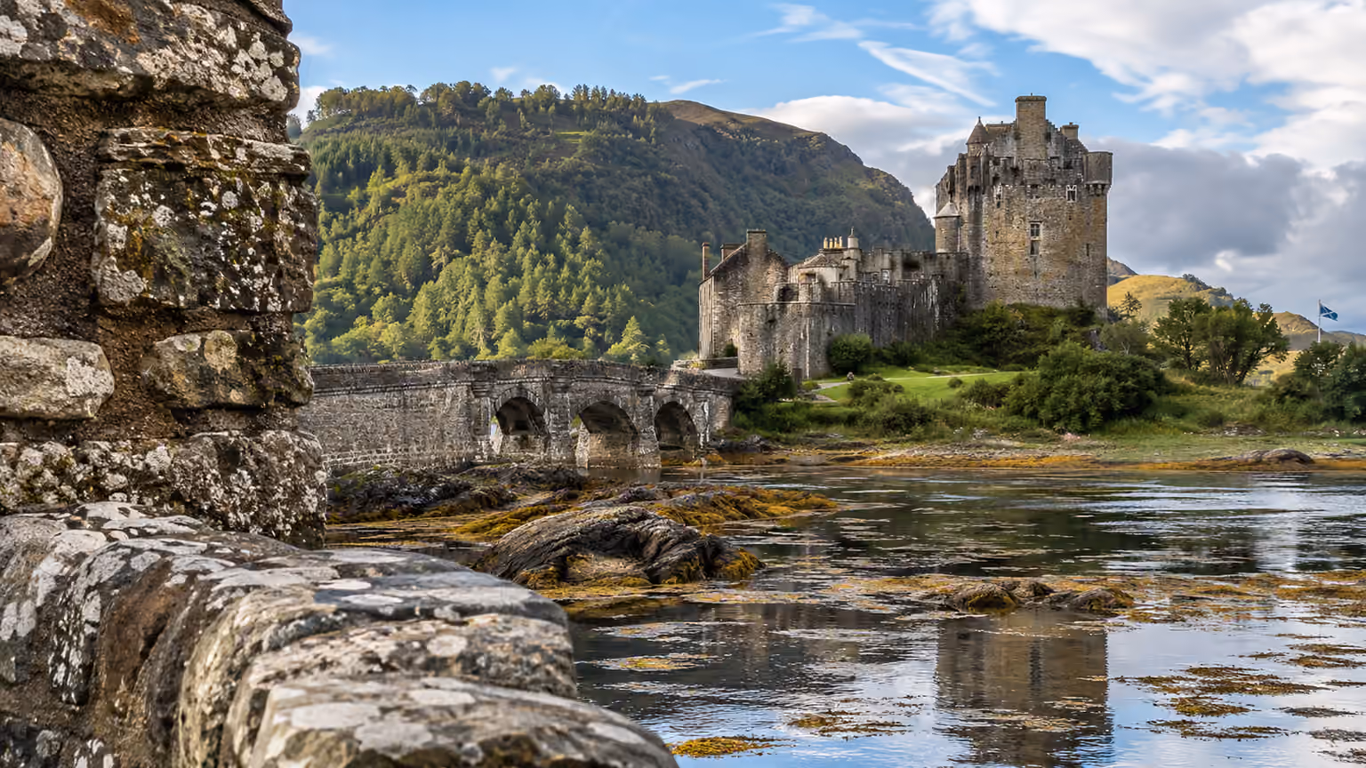 Close exterior detail of weathered Scottish stone masonry near Eilean Donan Castle with the tidal