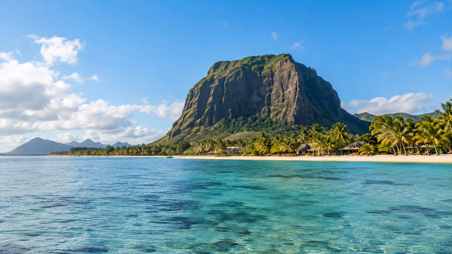 Le Morne Brabant Mauritius rising beyond a calm turquoise lagoon and coastal palms