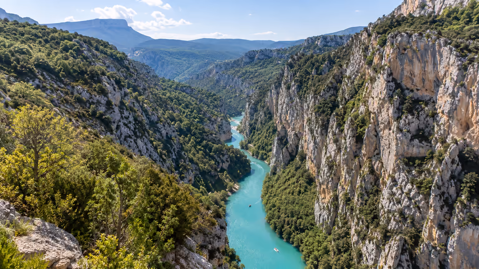 Verdon Gorge in France with steep pale limestone cliffs and natural blue-green river below