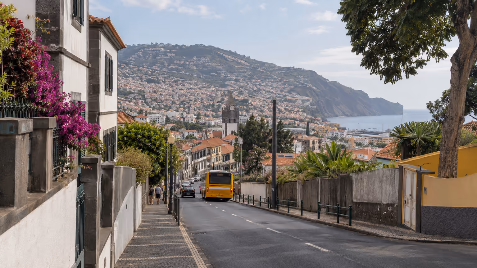 A Funchal public street with a local city bus seen at a distance