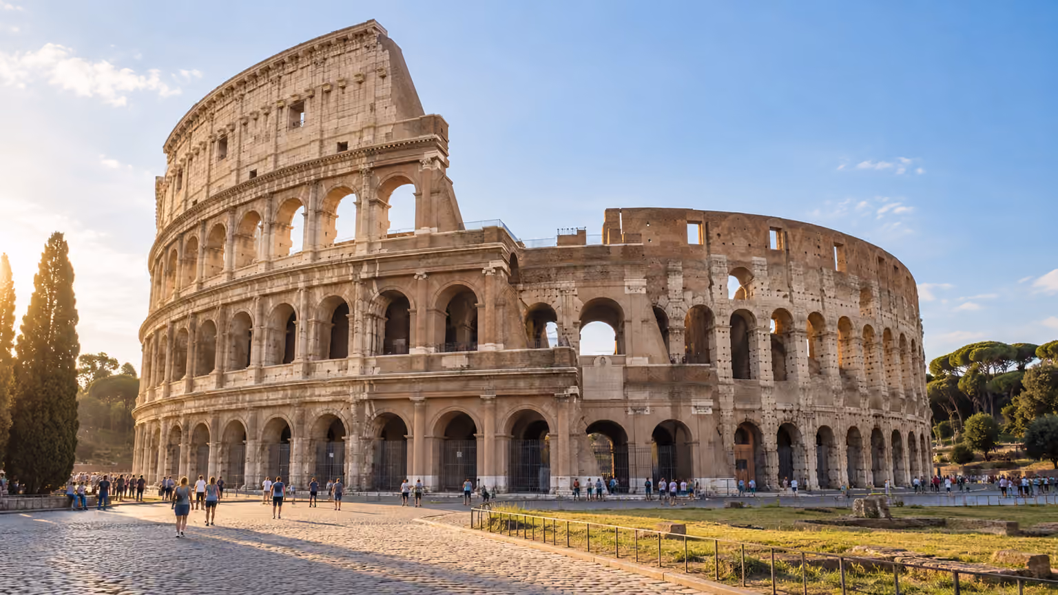 Weathered stone arches of an ancient Roman amphitheater in warm morning light