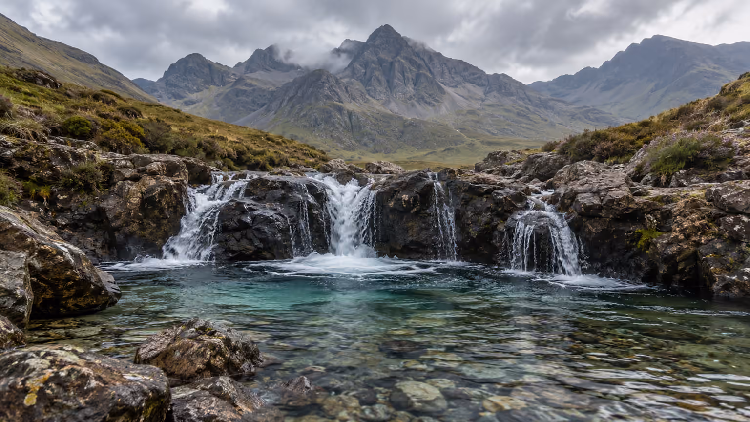 Clear turquoise pools and small waterfalls below the rugged Cuillin hills on Skye