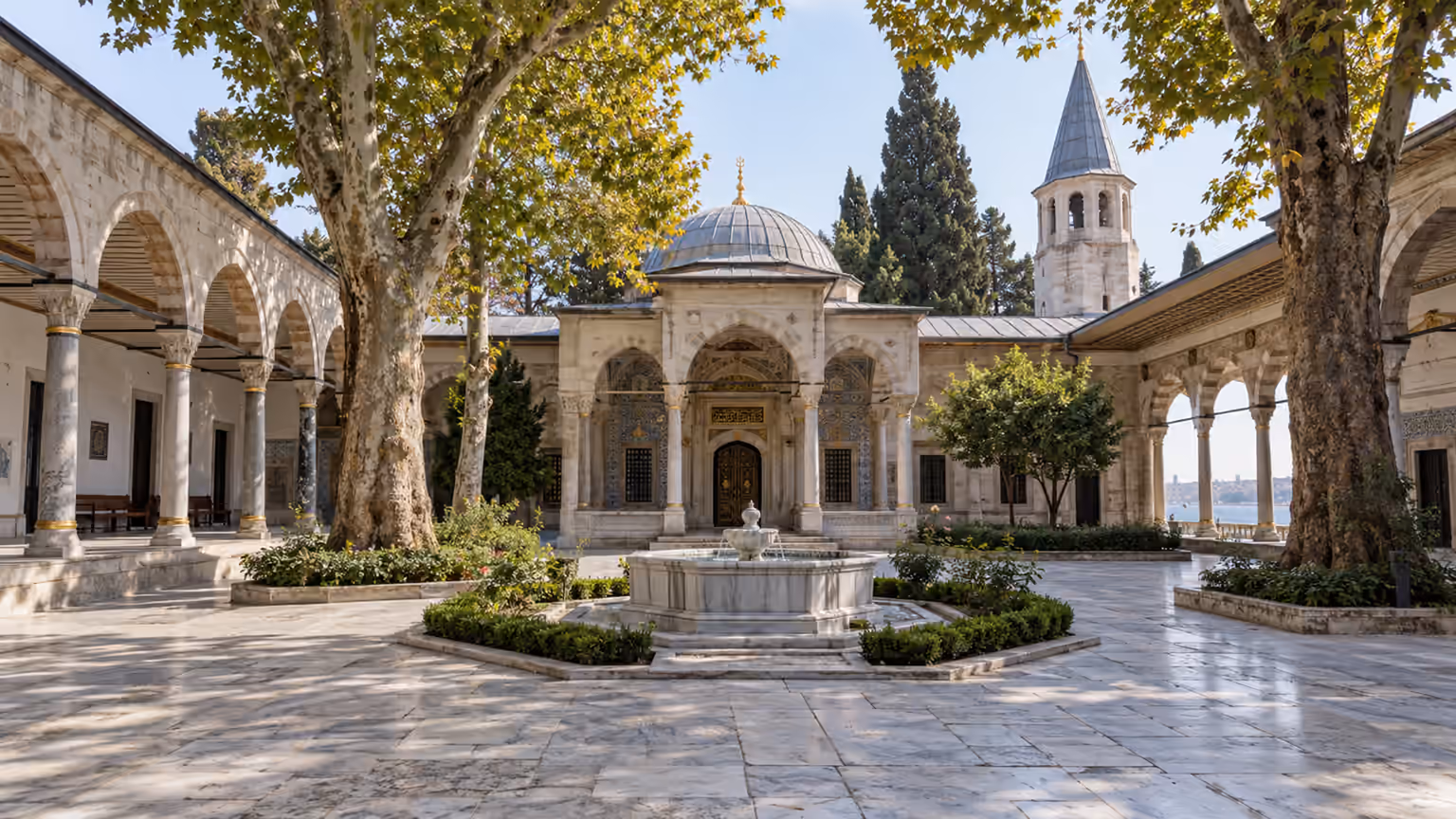 An Ottoman palace courtyard with arches and trees overlooking the Bosphorus