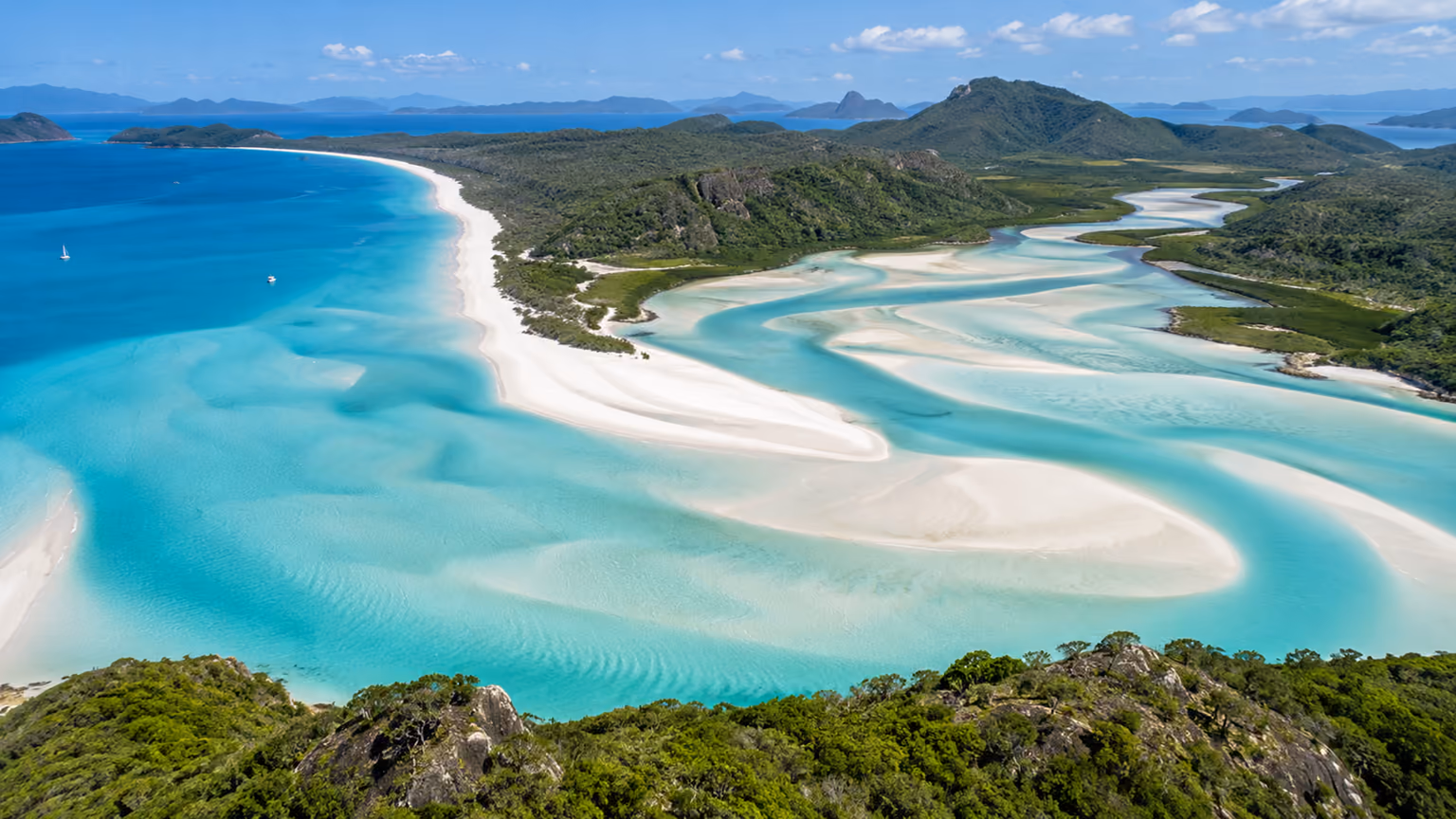 White sand and swirling turquoise tidal channels around Hill Inlet in the Whitsundays
